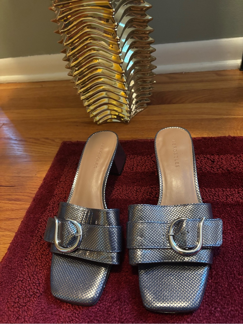 Aerosoles Evvie block heel slide sandals featuring a silver metallic snakeskin